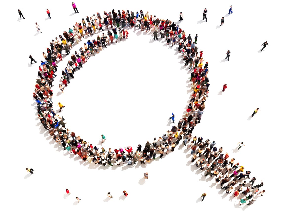 This image shows a magnifying glass made up of people on a white background. This is meant to illustrate a close analysis of customers in order to serve them better.