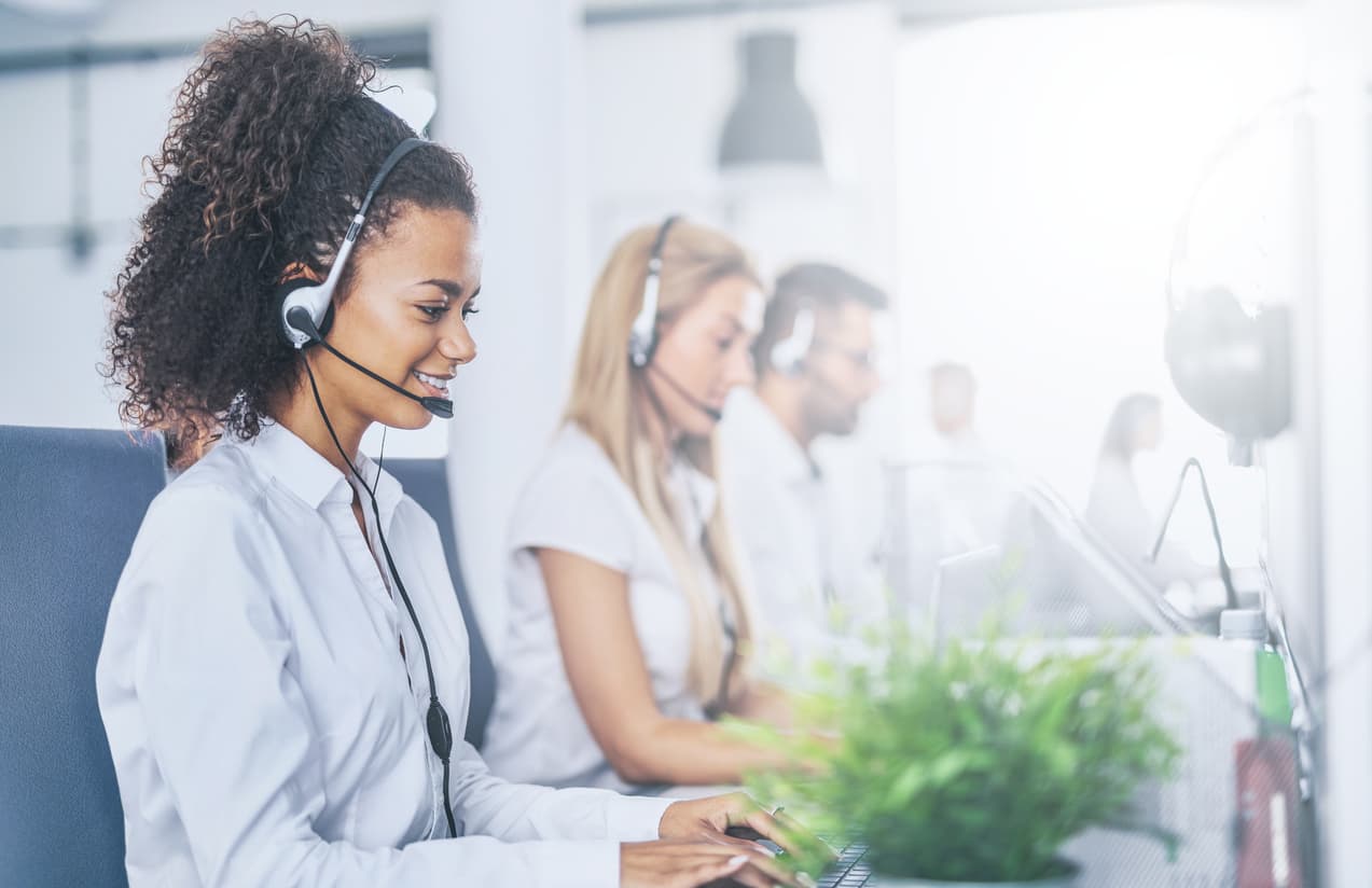 Happy agents working in an AWS Connect call center.