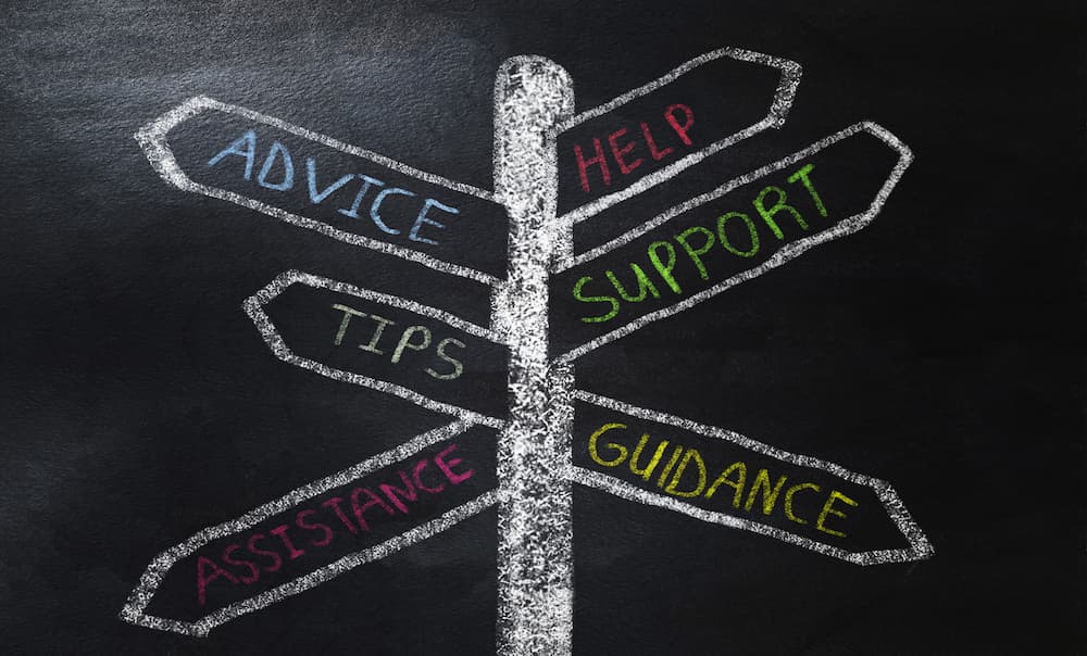 Chalkboard drawing in multiple colors with signs pointing to Help, Support, Guidance, Advice, Tips, and Assistance.