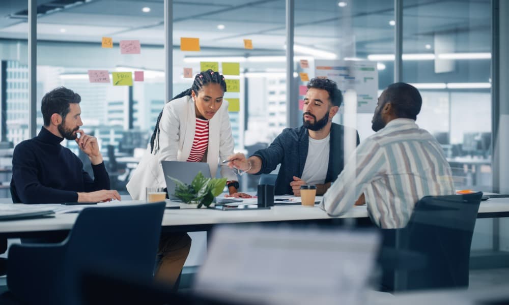 Employees have a meeting to explore the serverless benefits for startups.